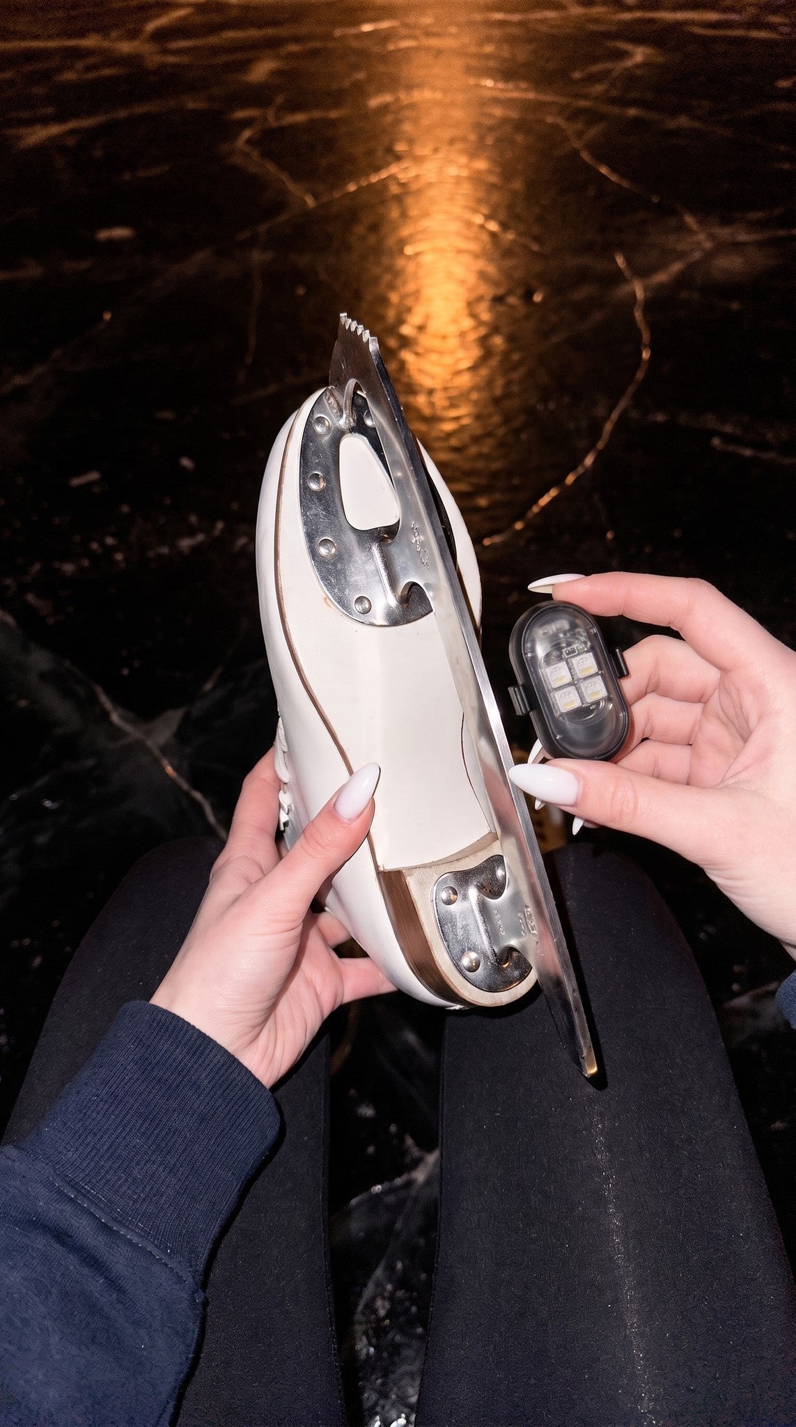 BladeLit LED pod held next to a figure skate